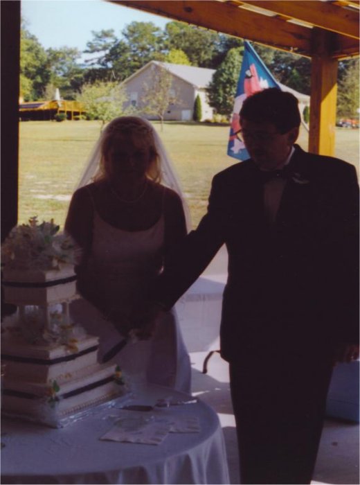Bride & Groom Cutting The Wedding Cake