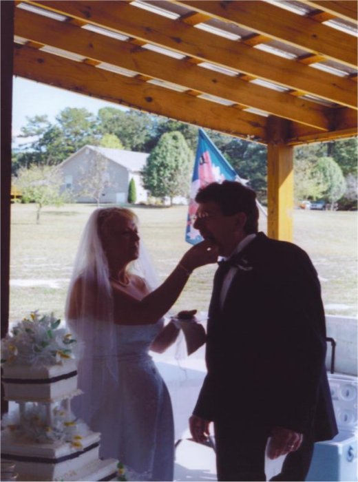 Bride Feeding Groom Wedding Cake